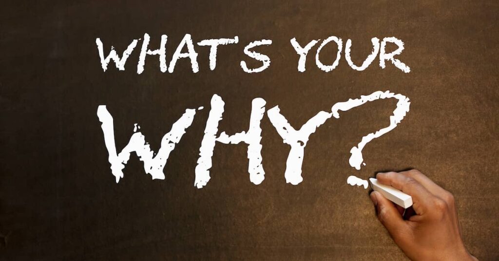 Hand writing 'What's Your Why?' in chalk | Twelve Three Media